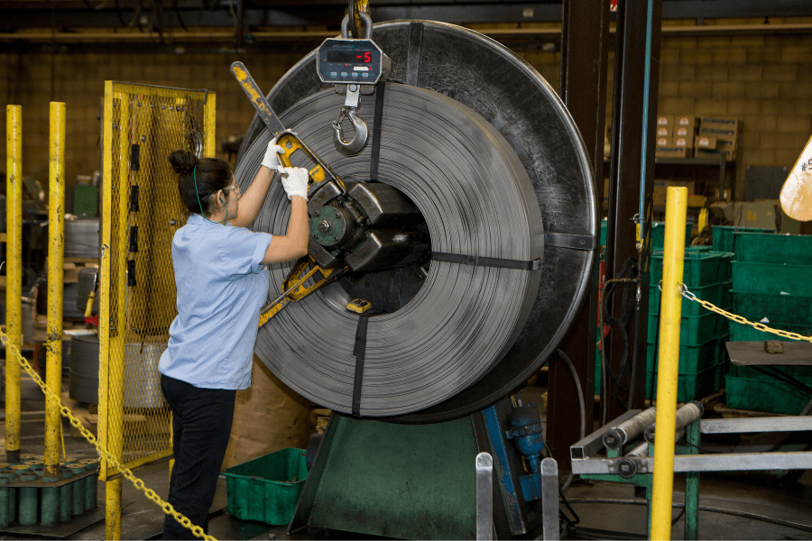 woman creating wire for retaining ring manufacturing